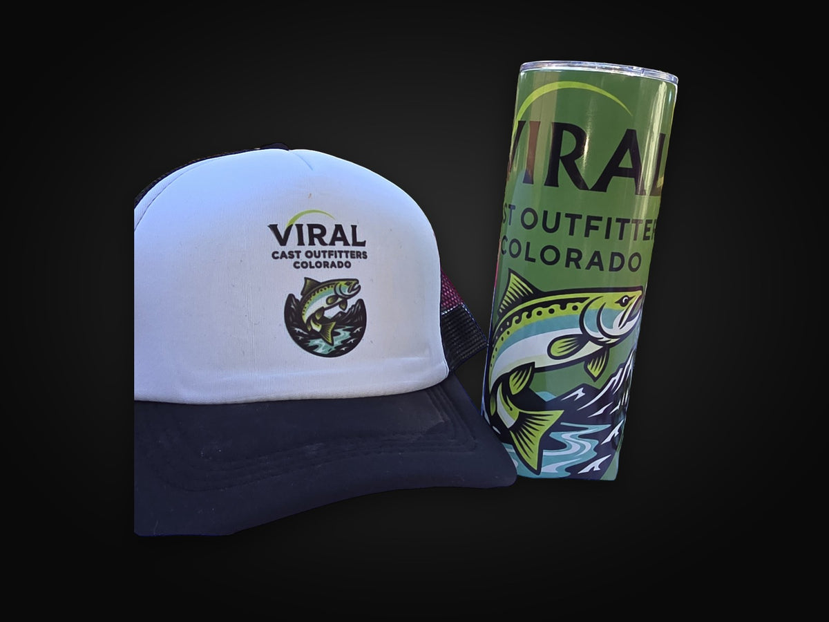 Green tumbler next to the black hat.