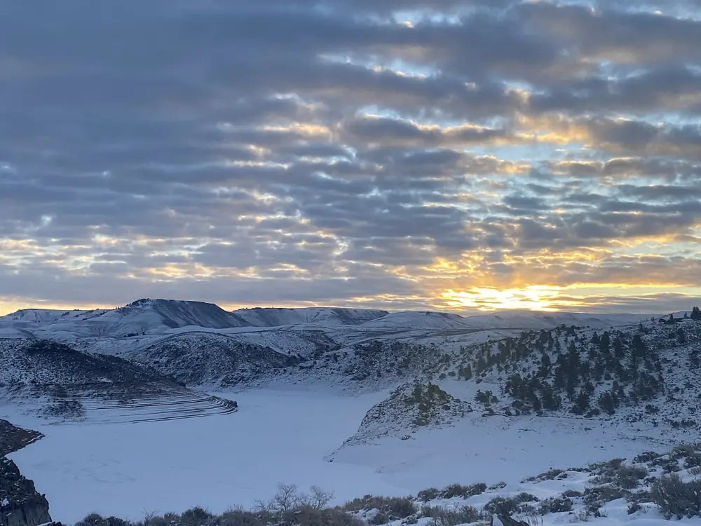Blue Mesa Reservoir in winter, frozen under evening clouds